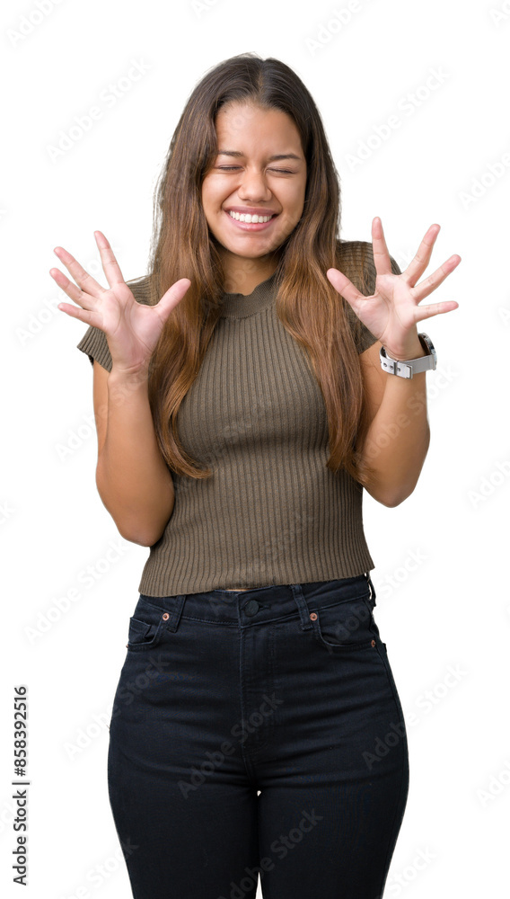Young beautiful brunette woman over isolated background celebrating mad and crazy for success with arms raised and closed eyes screaming excited. Winner concept Young beautiful brunette woman over isolated background celebrating mad and crazy for success with arms raised and closed eyes screaming excited. Winner concept