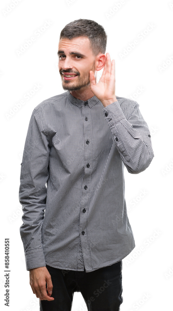 Young hipster man smiling with hand over ear listening an hearing to rumor or gossip. Deafness concept. Young hipster man smiling with hand over ear listening an hearing to rumor or gossip. Deafness concept.