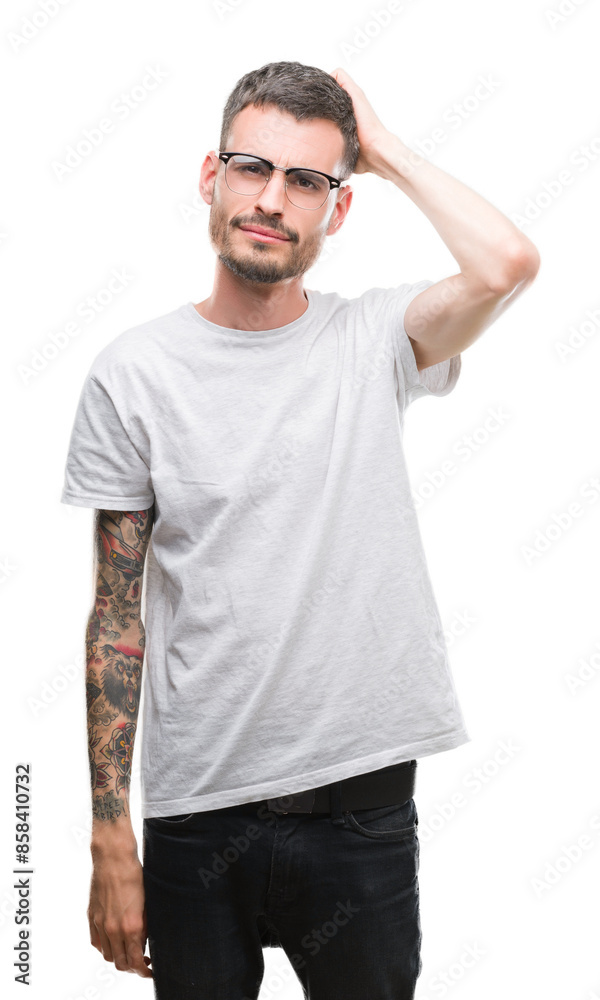 Young tattooed adult man confuse and wonder about question. Uncertain with doubt, thinking with hand on head. Pensive concept. Young tattooed adult man confuse and wonder about question. Uncertain with doubt, thinking with hand on head. Pensive concept.