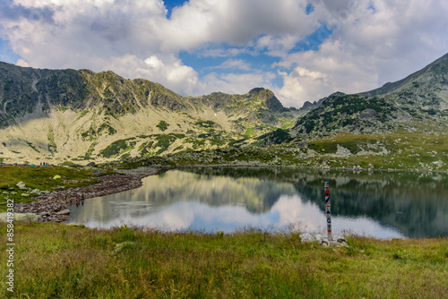 Fototapeta Naklejka Na Ścianę i Meble -  Bucura lake nestled among rolling hills in Retezat National Park, Romania
