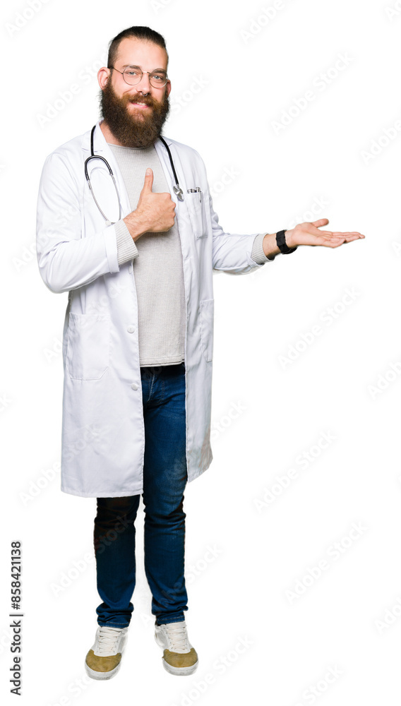 Young blond doctor man with beard wearing medical coat Showing palm hand and doing ok gesture with thumbs up, smiling happy and cheerful Young blond doctor man with beard wearing medical coat Showing palm hand and doing ok gesture with thumbs up, smiling happy and cheerful
