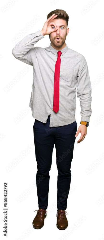 Young handsome business man doing ok gesture shocked with surprised face, eye looking through fingers. Unbelieving expression. Young handsome business man doing ok gesture shocked with surprised face, eye looking through fingers. Unbelieving expression.