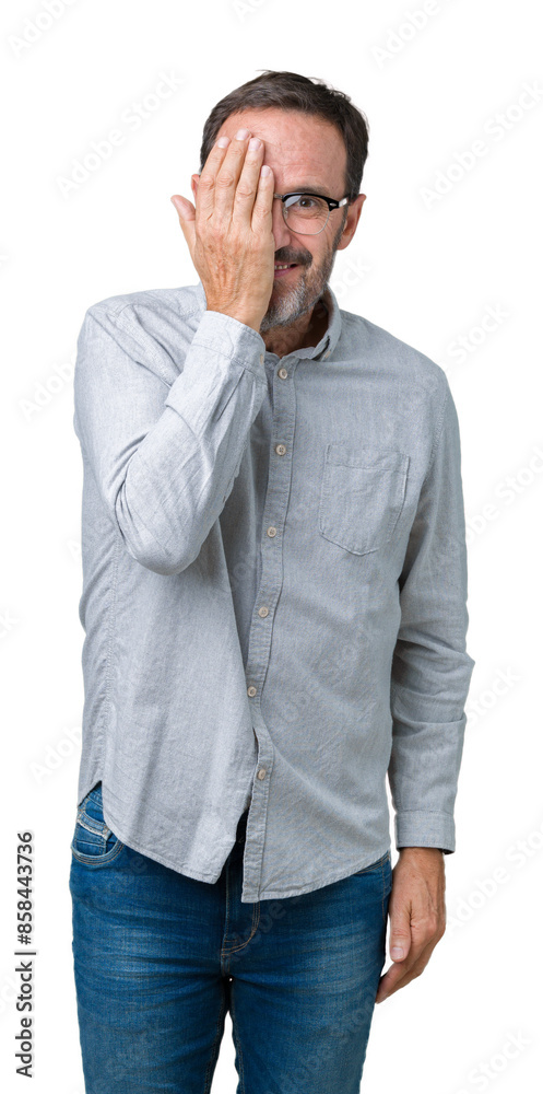 Handsome middle age elegant senior man wearing glasses over isolated background covering one eye with hand with confident smile on face and surprise emotion. Handsome middle age elegant senior man wearing glasses over isolated background covering one eye with hand with confident smile on face and surprise emotion.