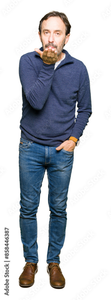Middle age handsome man wearing a sweater looking at the camera blowing a kiss with hand on air being lovely and sexy. Love expression. Middle age handsome man wearing a sweater looking at the camera blowing a kiss with hand on air being lovely and sexy. Love expression.