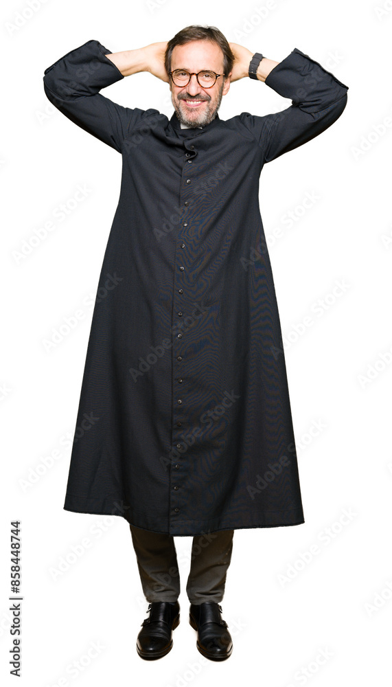 Middle age priest man wearing catholic robe Relaxing and stretching with arms and hands behind head and neck, smiling happy Middle age priest man wearing catholic robe Relaxing and stretching with arms and hands behind head and neck, smiling happy