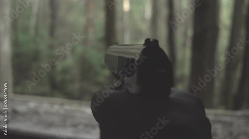 Russian pistol in hand first person view, special forces training in the forest photo