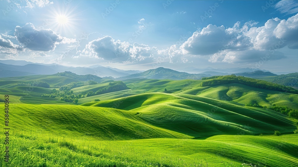 Fototapeta premium Rolling green hills bathed in sunlight on a sunny day, with a vast expanse of clear sky and scattered clouds