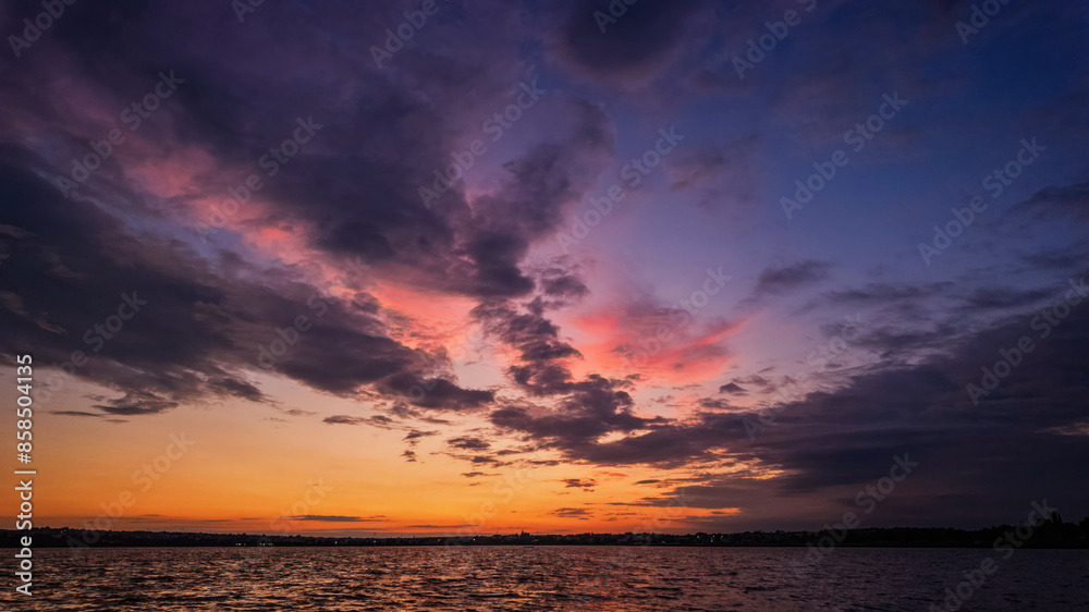 sunset over a tranquil lake with rippled water, sky with soft clouds sunset over a tranquil lake with rippled water, sky with soft clouds