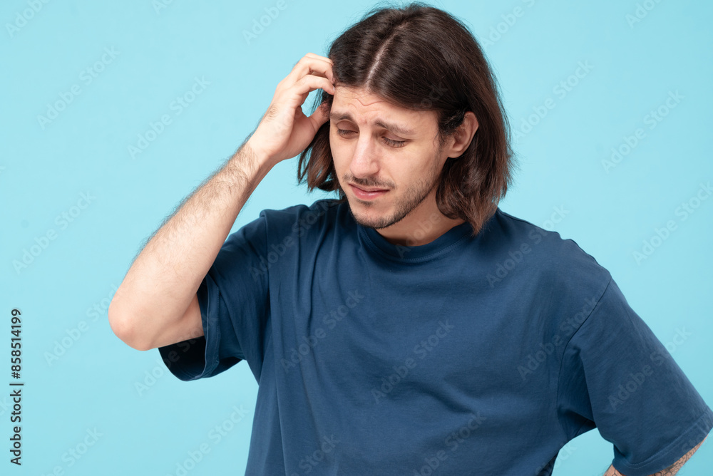 Middle eastern man on blue background having doubts with confused face expression. Concept of problems, medicine Middle eastern man on blue background having doubts with confused face expression. Concept of problems, medicine