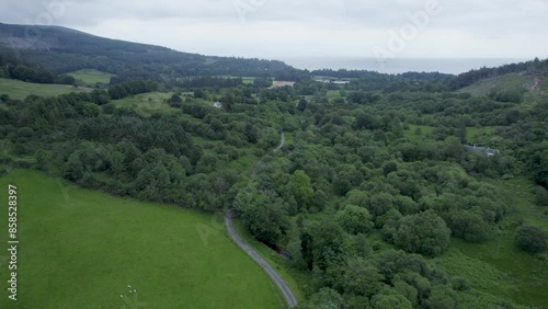 Aerial drone shot reveal of countryside house, flying over mountain shot, on the Isle Of Arran, Scotland