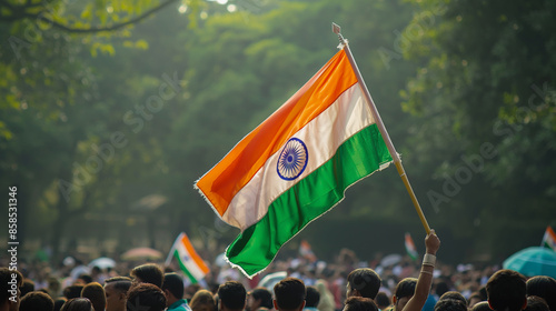 Woman holding huge Indian flag fluttering proudly in the wind photo
