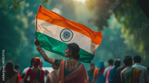 Woman holding huge Indian flag fluttering proudly in the wind photo