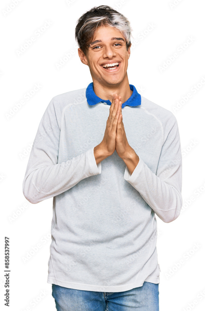 Young hispanic man wearing casual clothes praying with hands together asking for forgiveness smiling confident. Young hispanic man wearing casual clothes praying with hands together asking for forgiveness smiling confident.