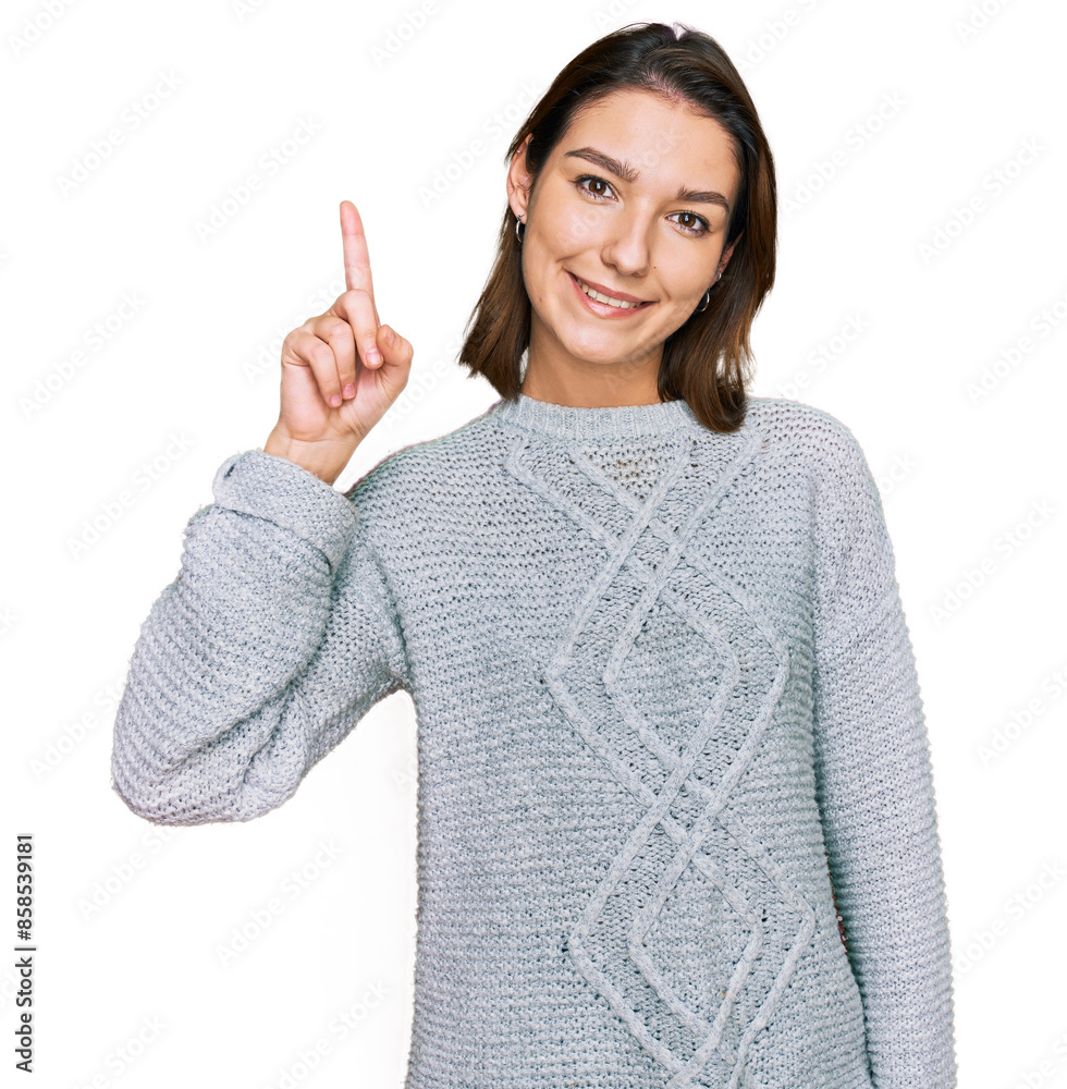 Young caucasian girl wearing casual clothes showing and pointing up with finger number one while smiling confident and happy. Young caucasian girl wearing casual clothes showing and pointing up with finger number one while smiling confident and happy.