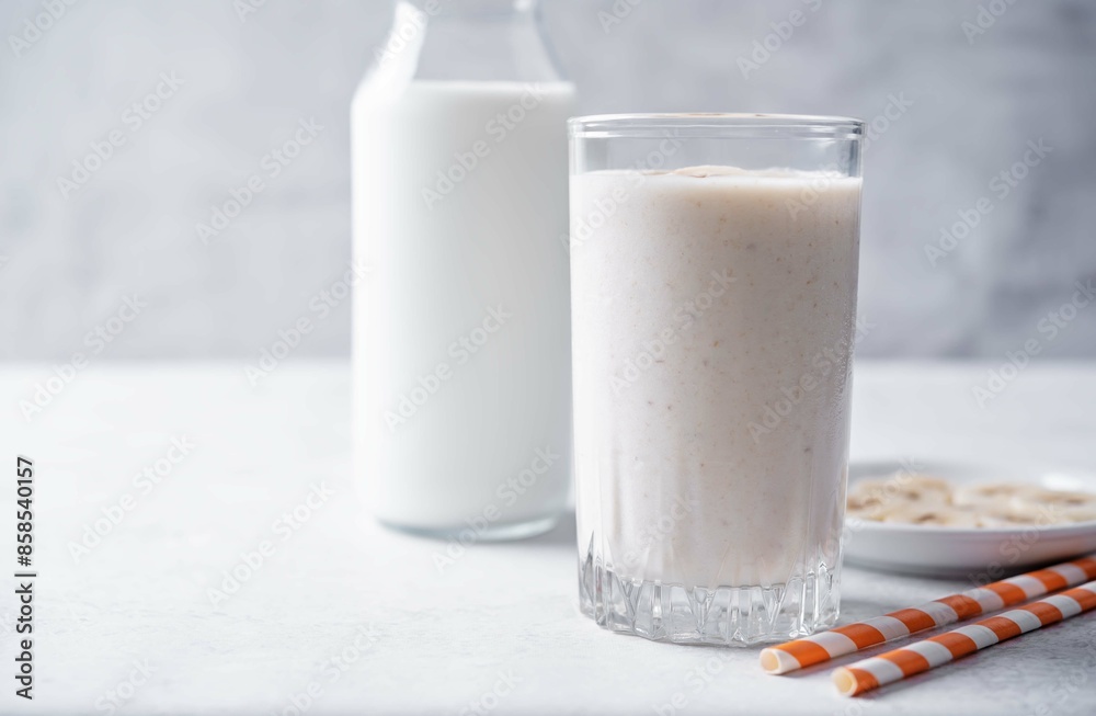 Banana milkshake with banana slices in a glass Banana milkshake with banana slices in a glass