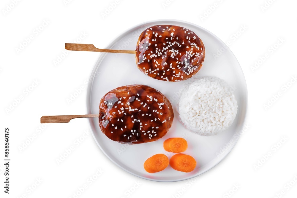 Tsukune, Japanese Chicken Meatball in teriyaki sauce with sesame seeds sprinkles with rice and vegetables in a plate on a white isolated background Tsukune, Japanese Chicken Meatball in teriyaki sauce with sesame seeds sprinkles with rice and vegetables in a plate on a white isolated background