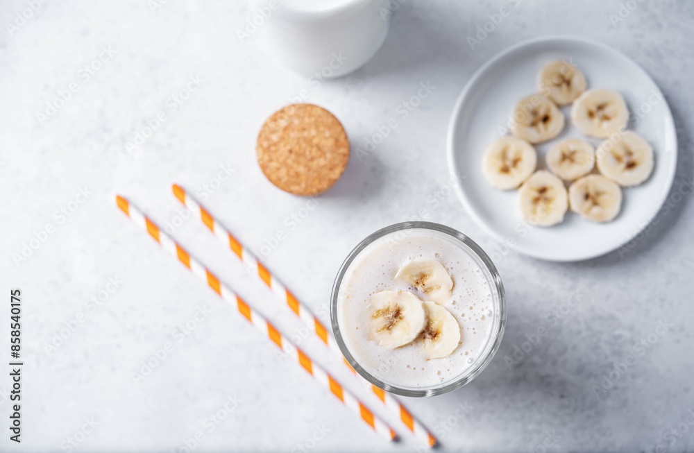 Banana milkshake with banana slices in a glass Banana milkshake with banana slices in a glass
