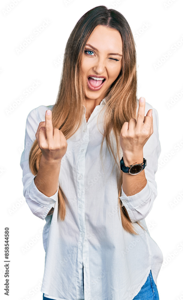 Beautiful caucasian woman wearing casual white shirt showing middle finger doing fuck you bad expression, provocation and rude attitude. screaming excited