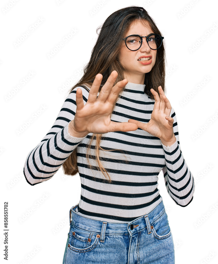 Young beautiful teen girl wearing casual clothes and glasses disgusted expression, displeased and fearful doing disgust face because aversion reaction. with hands raised Young beautiful teen girl wearing casual clothes and glasses disgusted expression, displeased and fearful doing disgust face because aversion reaction. with hands raised