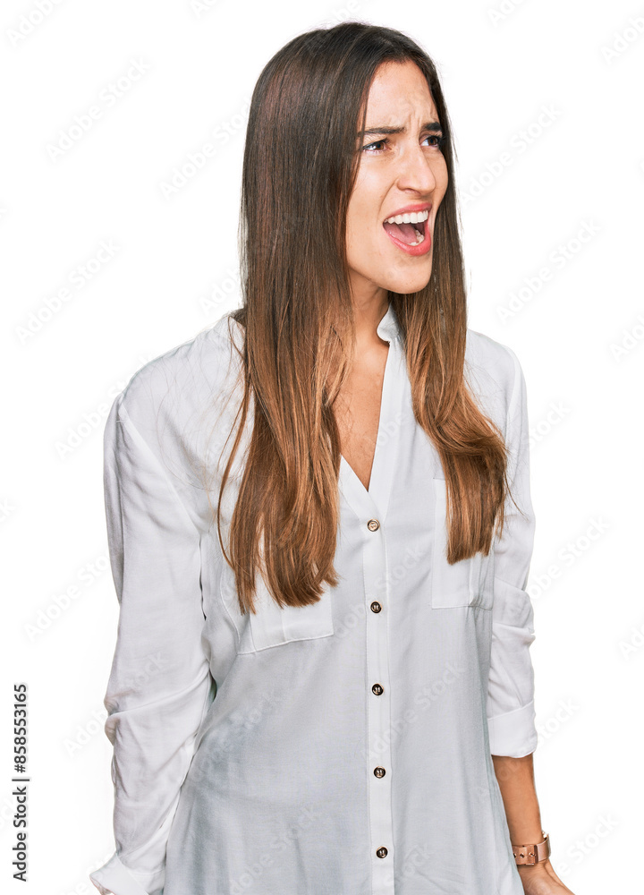 Young beautiful woman wearing casual clothes angry and mad screaming frustrated and furious, shouting with anger. rage and aggressive concept. Young beautiful woman wearing casual clothes angry and mad screaming frustrated and furious, shouting with anger. rage and aggressive concept.