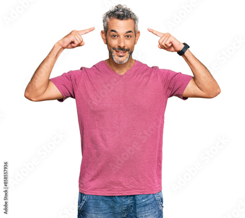 Middle age grey-haired man wearing casual clothes smiling pointing to head with both hands finger, great idea or thought, good memory