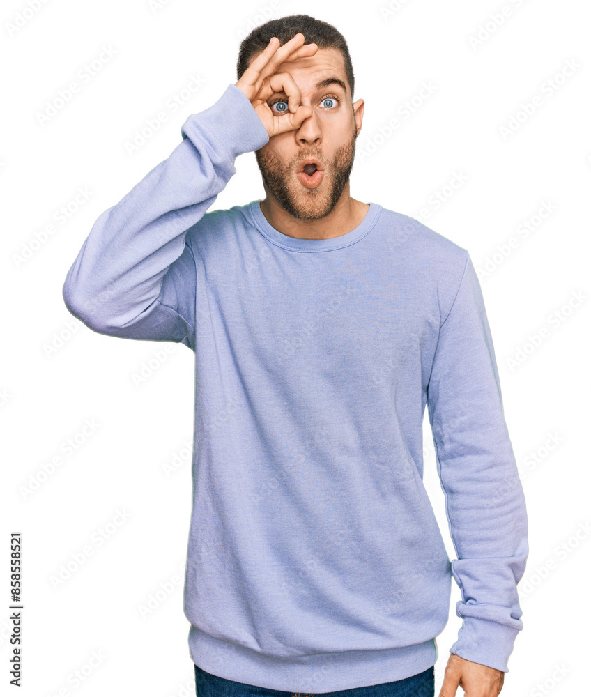 Young caucasian man wearing casual clothes doing ok gesture shocked with surprised face, eye looking through fingers. unbelieving expression. Young caucasian man wearing casual clothes doing ok gesture shocked with surprised face, eye looking through fingers. unbelieving expression.