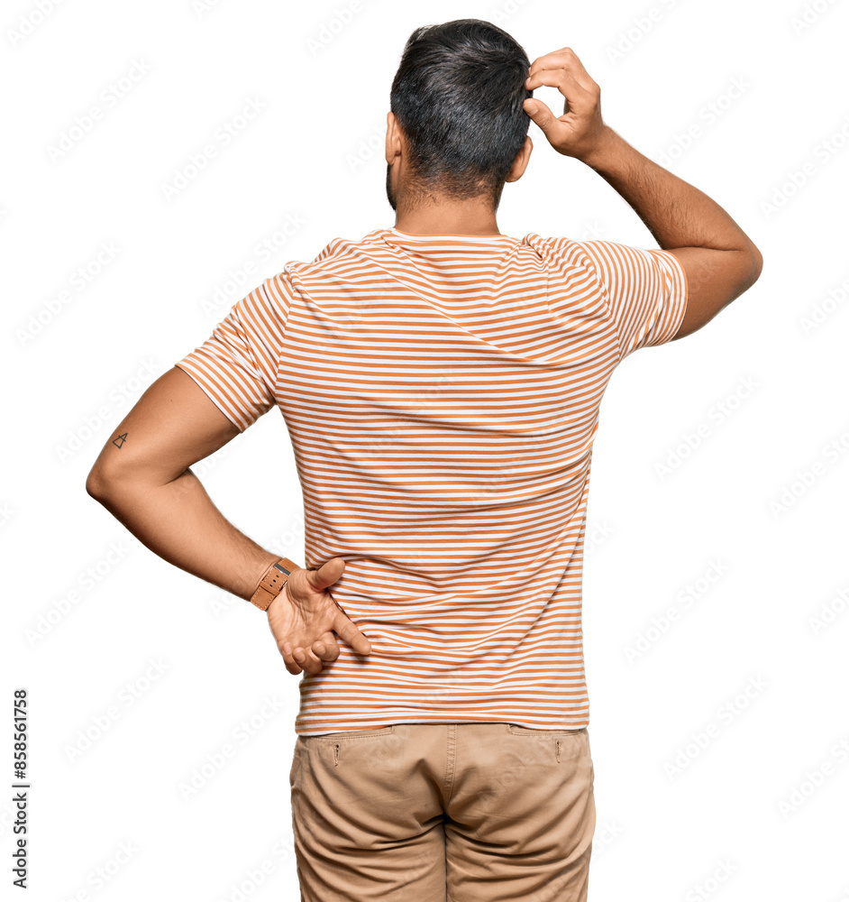 Handsome hispanic man wearing casual clothes backwards thinking about doubt with hand on head Handsome hispanic man wearing casual clothes backwards thinking about doubt with hand on head