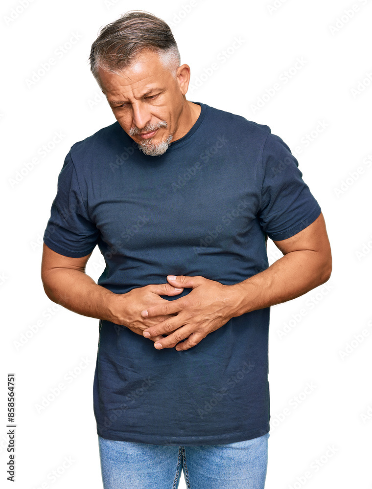 Middle age grey-haired man wearing casual clothes with hand on stomach because indigestion, painful illness feeling unwell. ache concept. Middle age grey-haired man wearing casual clothes with hand on stomach because indigestion, painful illness feeling unwell. ache concept.