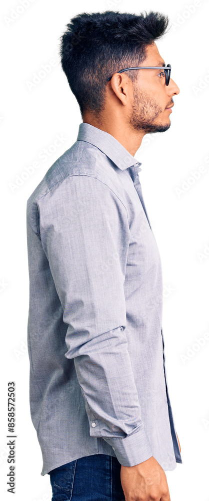 Handsome latin american young man wearing business clothes and glasses looking to side, relax profile pose with natural face with confident smile. Handsome latin american young man wearing business clothes and glasses looking to side, relax profile pose with natural face with confident smile.