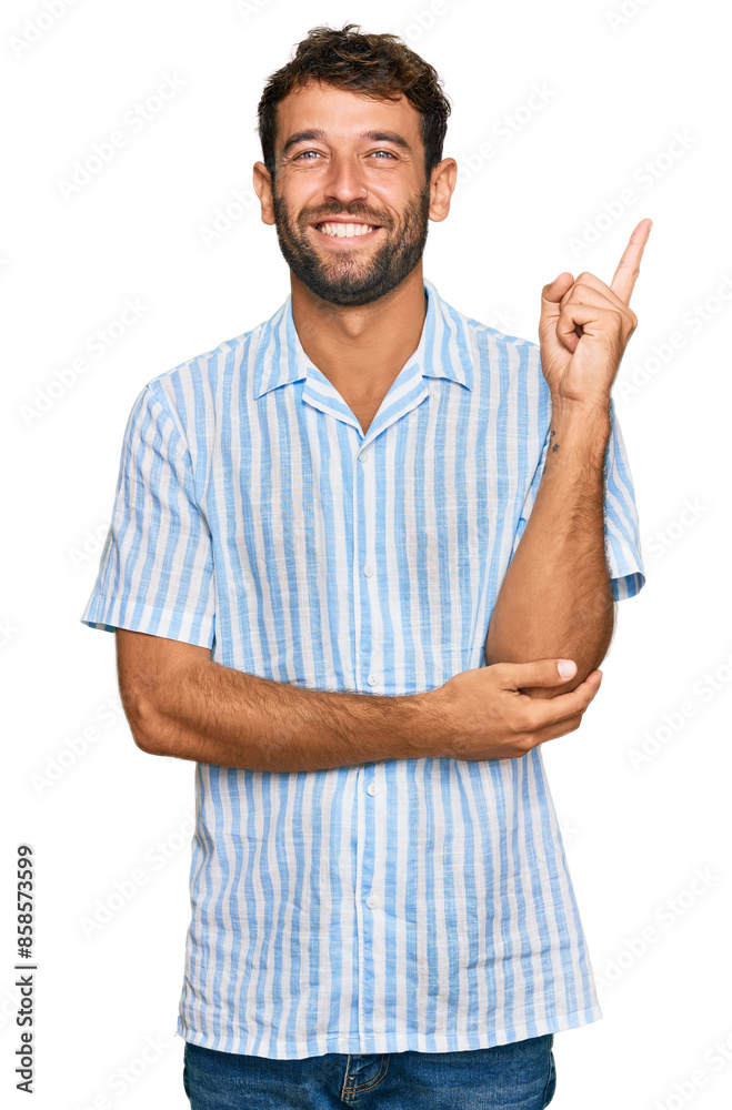 Handsome young man with beard wearing casual fresh shirt with a big smile on face, pointing with hand and finger to the side looking at the camera. Handsome young man with beard wearing casual fresh shirt with a big smile on face, pointing with hand and finger to the side looking at the camera.