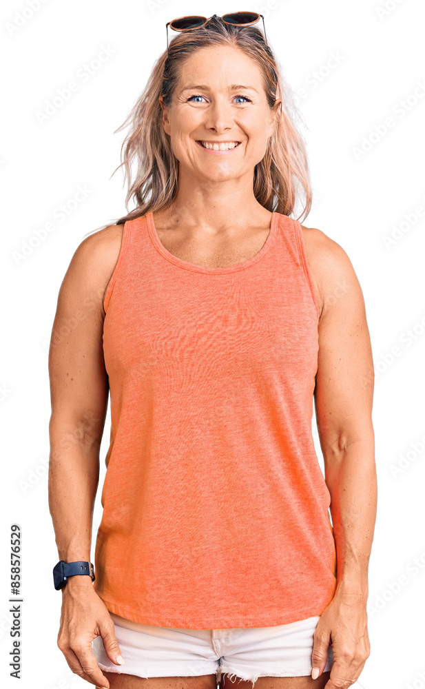 Fototapeta premium Middle age fit blonde woman wearing casual summer clothes and sunglasses with a happy and cool smile on face. lucky person.