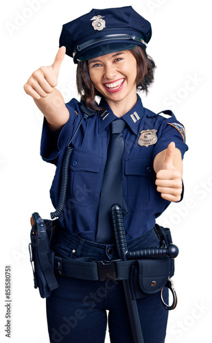 Young beautiful girl wearing police uniform approving doing positive gesture with hand, thumbs up smiling and happy for success. winner gesture.