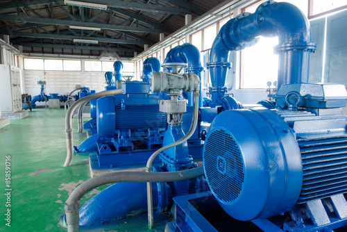 An electric motor drives a water pump. Several machines, in water treatment plants