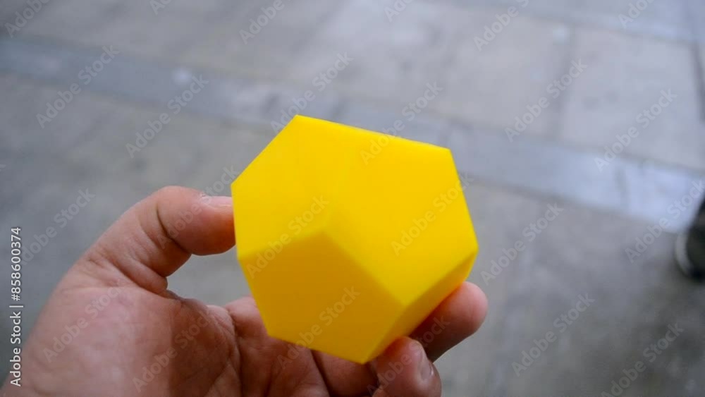A person holding in his hand an object printed on a 3D printer ...