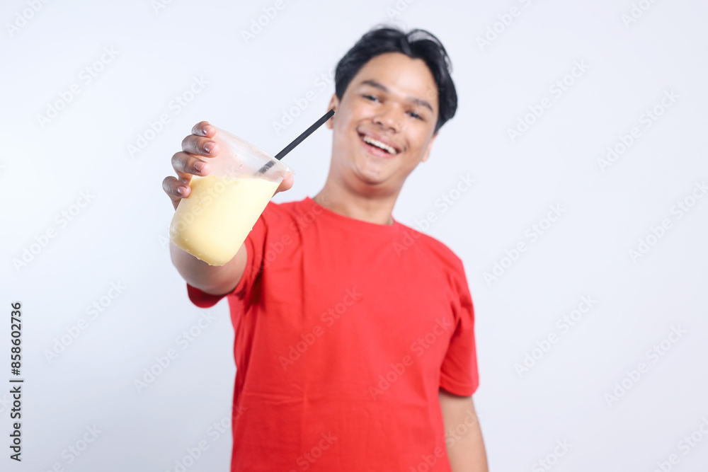 Portrait Of Friendly Young Asian Man Recommending Drink Juice Isolated On White Background Portrait Of Friendly Young Asian Man Recommending Drink Juice Isolated On White Background