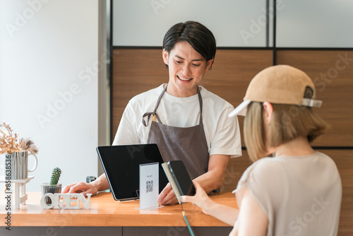 Photos カフェのレジ・会計で電子決済・スマホ決済に対応するカフェ店員