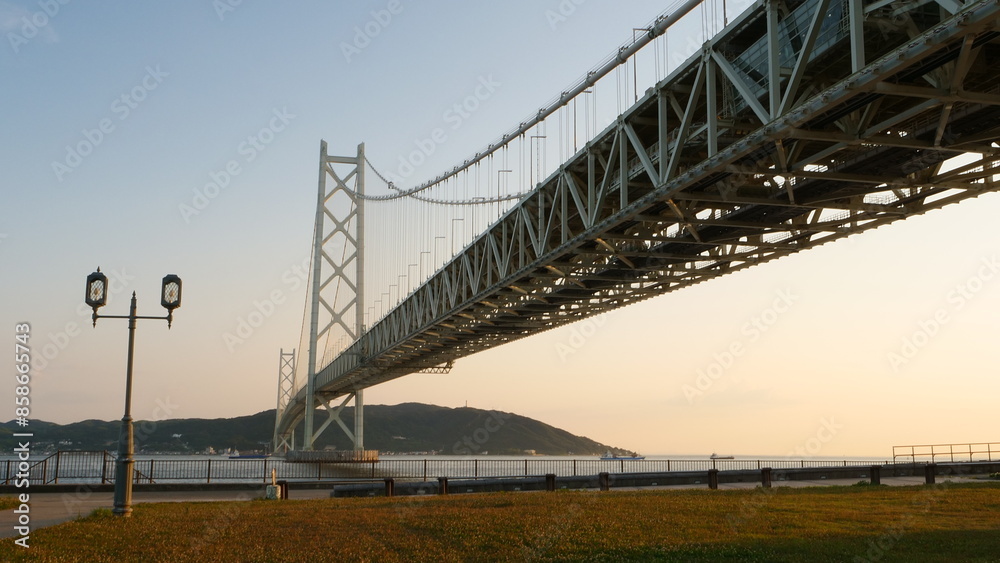 Akashi Kaikyo Bridge. Sunset view of ships passing by. Akashi Kaikyo Bridge. Sunset view of ships passing by.