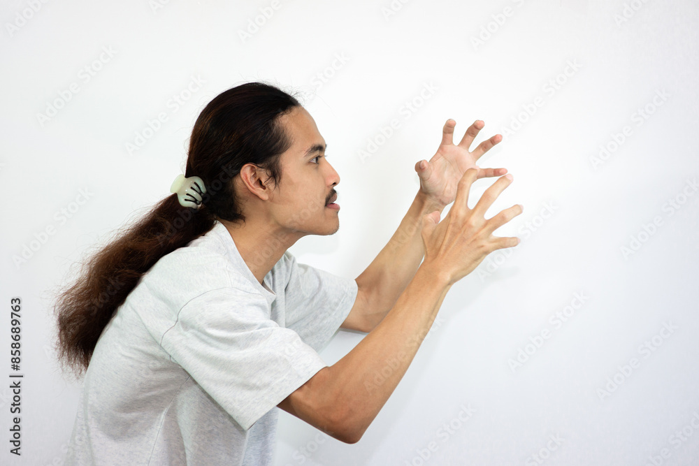Annoyed and angry man raising hands and clench teeth outraged, going to kill someone. Annoyed and angry man raising hands and clench teeth outraged, going to kill someone.