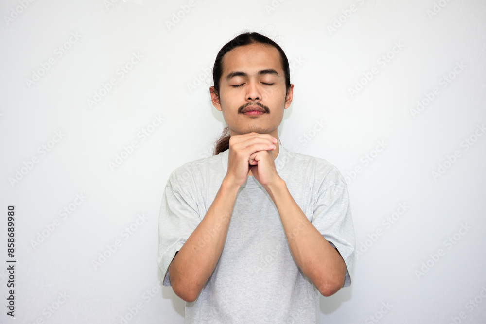 Praying, man and hands in meditation or worship of God because of faith or belief in spirituality. isolated in white background Praying, man and hands in meditation or worship of God because of faith or belief in spirituality. isolated in white background