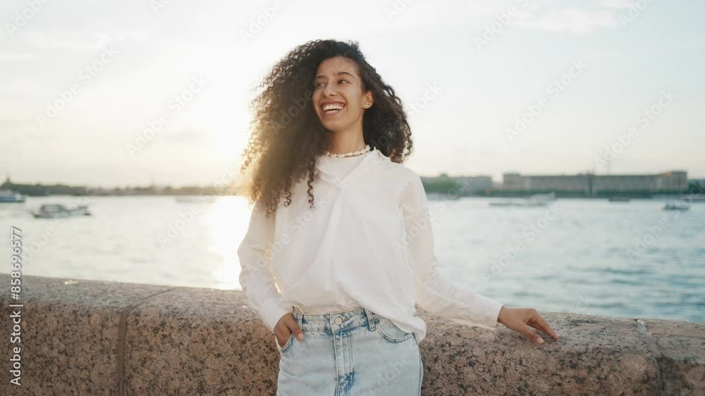 Happy Hispanic young woman in beautiful harbor, girl on embankment, portrait. Medium shot with pretty mixed-race lady resting on city quay near sea, traveling in summer vacation, positive emotions Happy Hispanic young woman in beautiful harbor, girl on embankment, portrait. Medium shot with pretty mixed-race lady resting on city quay near sea, traveling in summer vacation, positive emotions