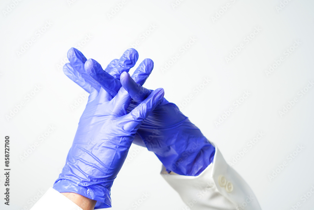 Stop gesture, arms crossed in purple gloves, sign protest, rejection, on white background Stop gesture, arms crossed in purple gloves, sign protest, rejection, on white background