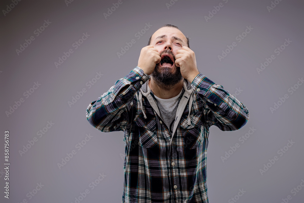Bearded man pulling a painful face in despair Bearded man pulling a painful face in despair