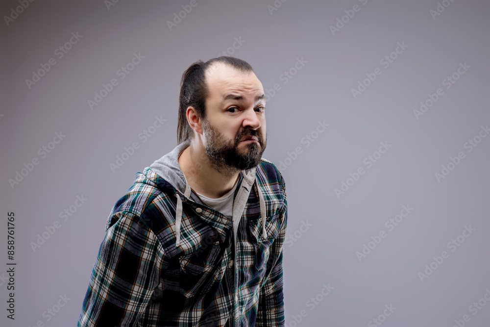 Fototapeta premium Bearded man with checkered shirt making a funny face expression
