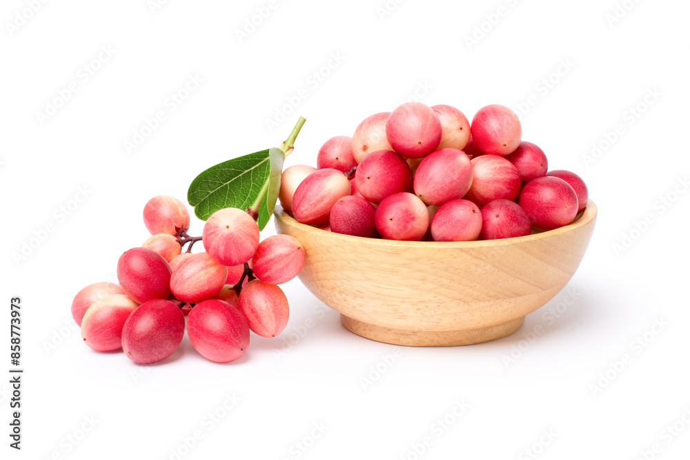 Carissa carandas fruit in wooden bowl isolated on white background. Carissa carandas fruit in wooden bowl isolated on white background.