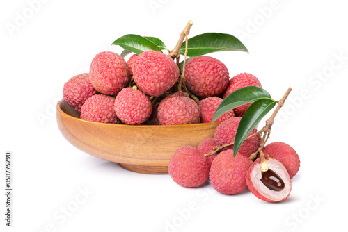 Fresh Lychee fruit with green leaves in wooden bowl isolated on white background. photo