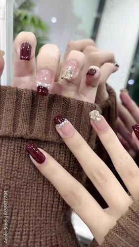 A woman with long nails and a sweater, exuding elegance and style.