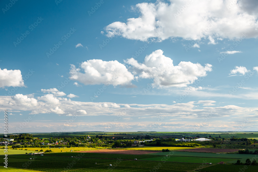 Fototapeta premium A fantastic cumulus clouds over the horizon on a sunny summer day.