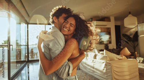 A joyous couple embraces in their new home, celebrating the exciting chapter of homeownership