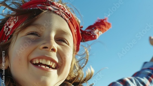 A vintage bandana being flung through the air by a happy child. photo