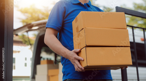 Asian delivery express courier young man use giving boxes to woman customer he wearing protective face mask at front home photo